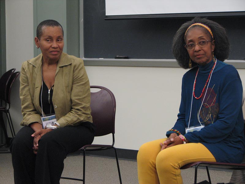 Gloria taking questions with independent artist Sonia Baez-Hernandez as translator